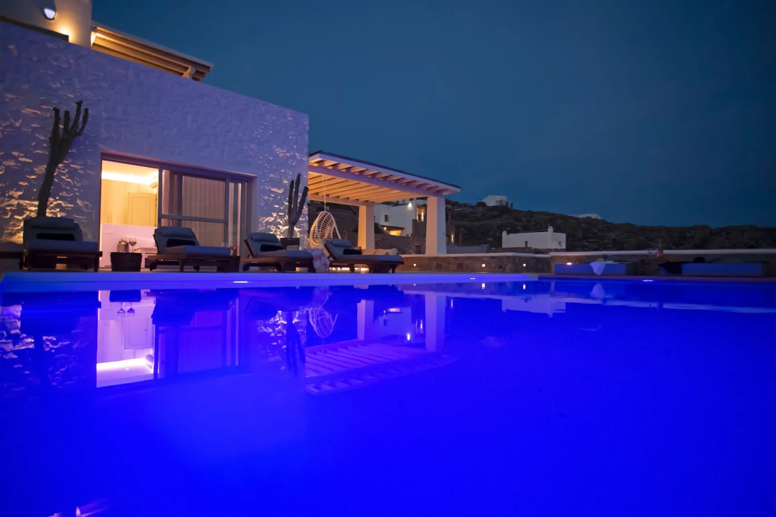 Luxury villa pool lit up at night