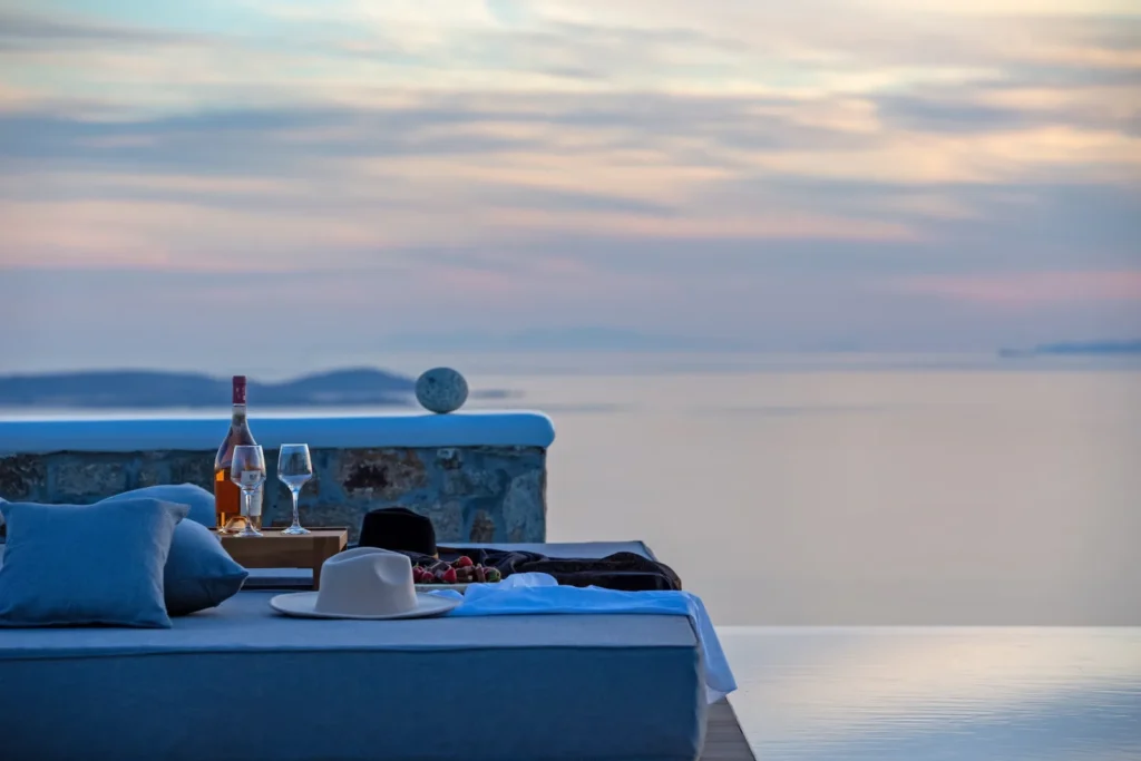 Luxury villa terrace in Mykonos with sunset sea view and wine