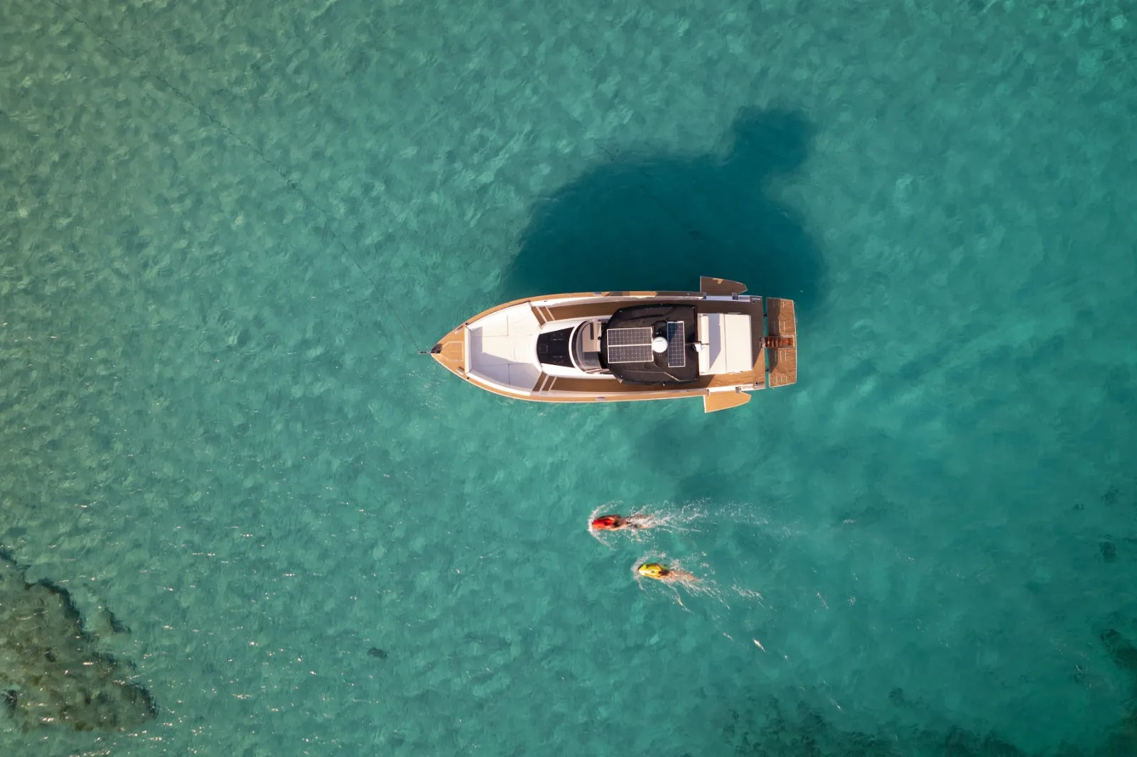Private boat swim stop in a turquoise Aegean cove