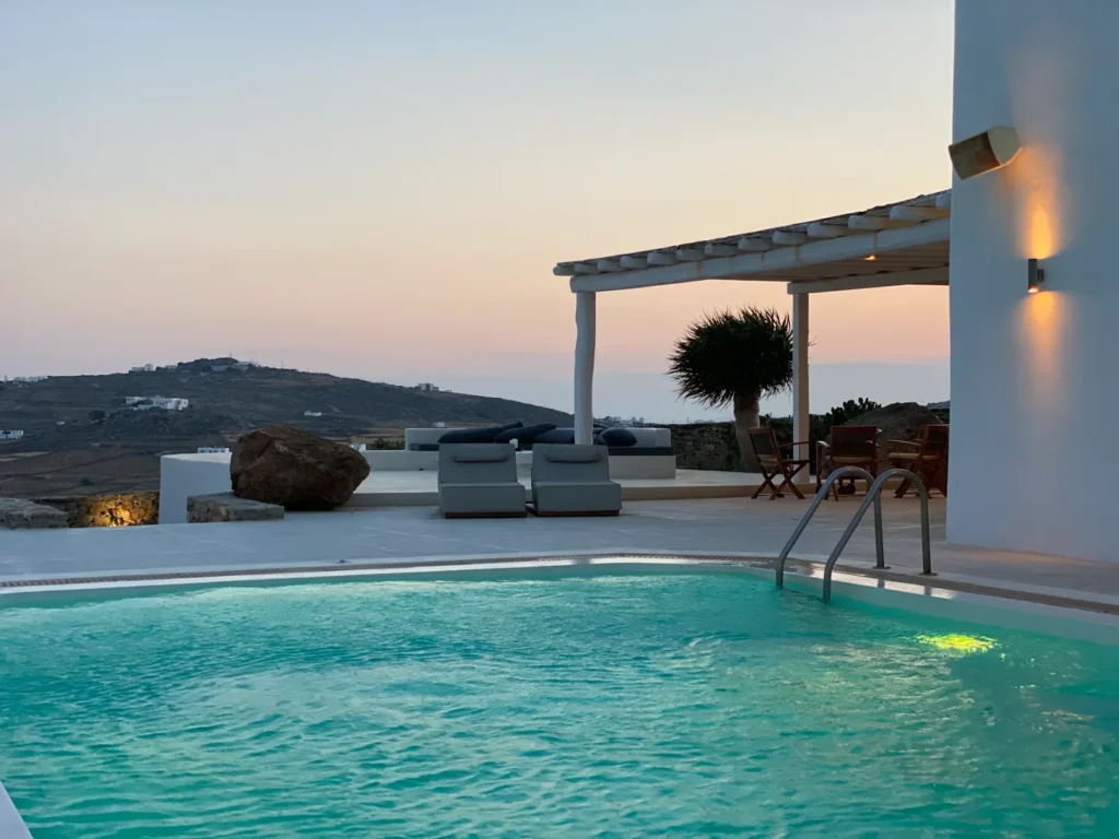 Villa infinity pool at sunset over the Aegean